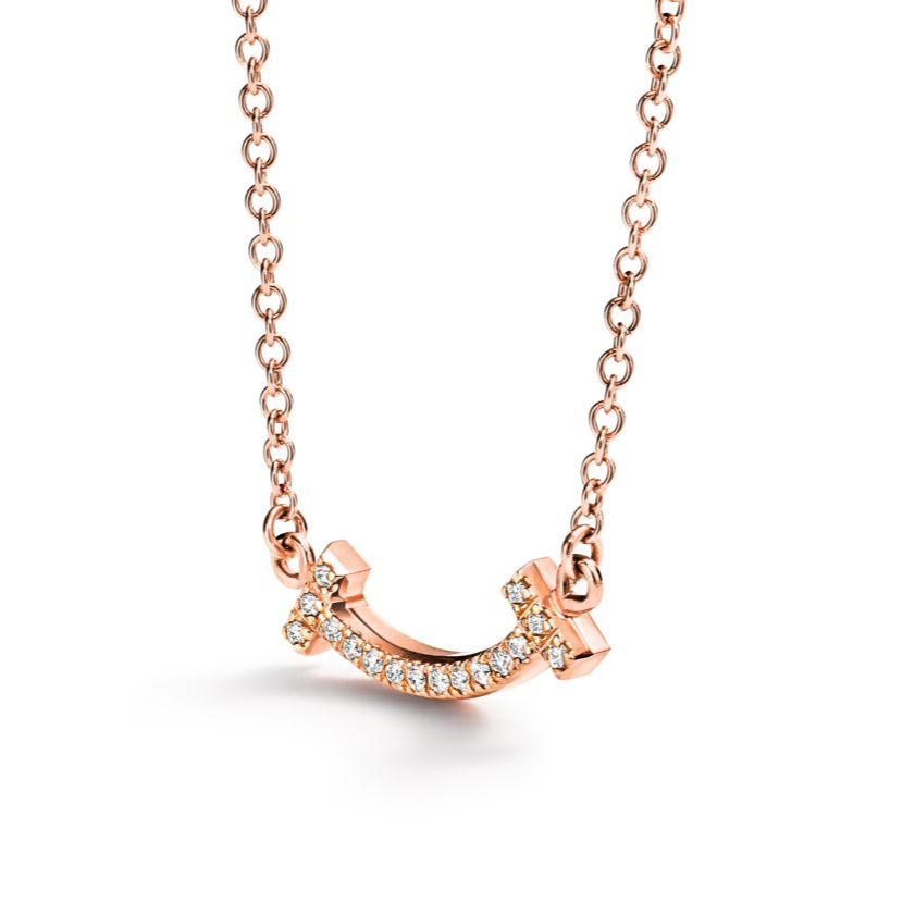 Elegant rose gold necklace featuring a sleek “T” pendant adorned with sparkling premium diamond simulants. The pendant hangs on a delicate adjustable chain, radiating modern luxury and timeless sophistication.