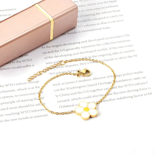 Gold daisy bracelet with white enamel flower charm