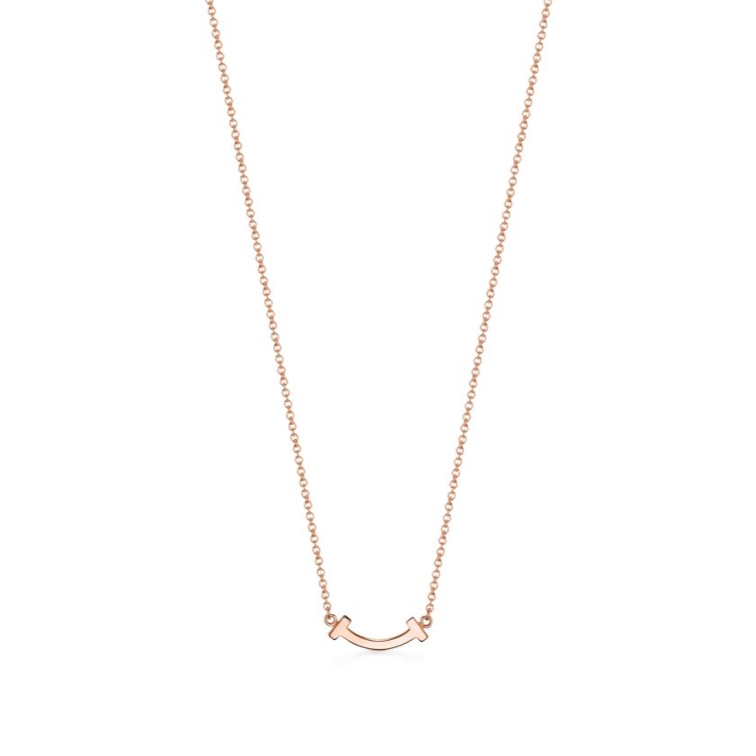 Elegant rose gold necklace featuring a sleek “T” pendant adorned with sparkling premium diamond simulants. The pendant hangs on a delicate adjustable chain, radiating modern luxury and timeless sophistication.