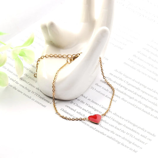 Gold bracelet with red enamel heart charm minimalist design