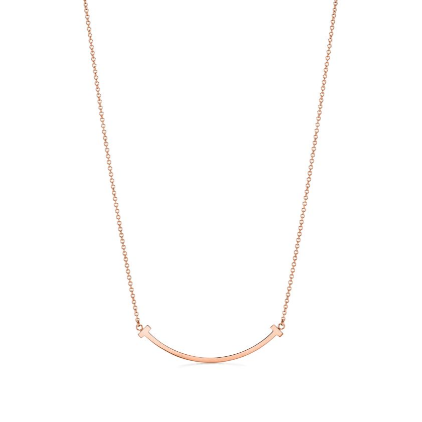Elegant rose gold necklace featuring a sleek “T” pendant adorned with sparkling premium diamond simulants. The pendant hangs on a delicate adjustable chain, radiating modern luxury and timeless sophistication.