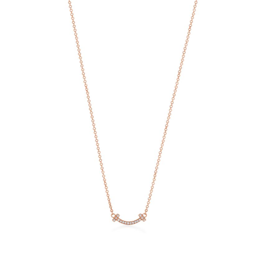 Elegant rose gold necklace featuring a sleek “T” pendant adorned with sparkling premium diamond simulants. The pendant hangs on a delicate adjustable chain, radiating modern luxury and timeless sophistication.