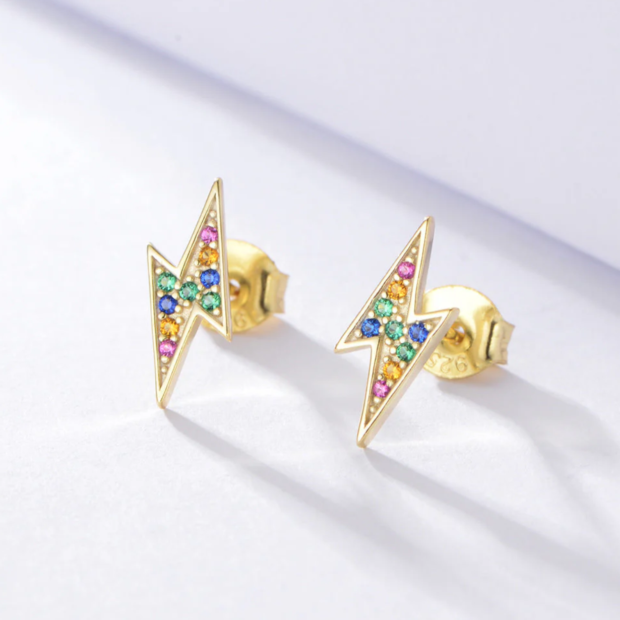  925 sterling silver base
• 18K gold PVD plating for long-lasting shine
• Multi-colour diamond simulants
• Mini lightning bolt design
• Lightweight and comfortable for everyday wear
• Hypoallergenic &amp; tarnish-resistant
• Perfect for stacking or wearing solo
• Ideal for gifting or adding a playful luxe touch