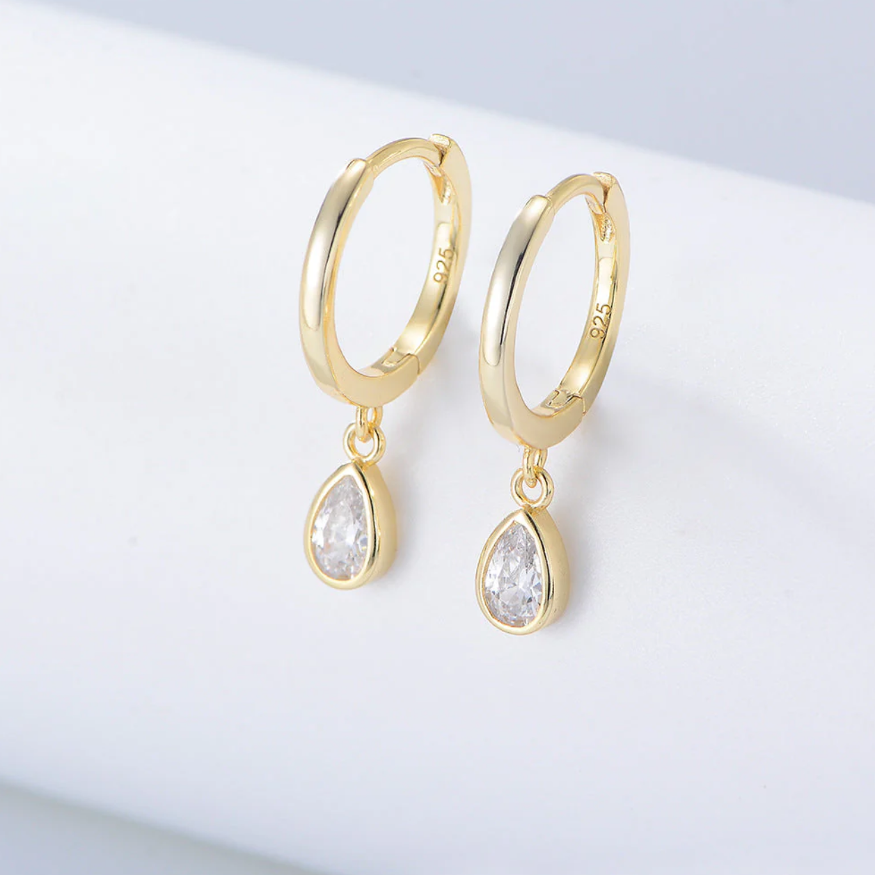 Add refined elegance to your everyday look with The Pear Drop, a pair of luminous gold drop earrings designed to move effortlessly with you. Crafted from premium 925 sterling silver and finished with 18K gold PVD plating, these earrings offer lasting brilliance, strength, and modern luxury.