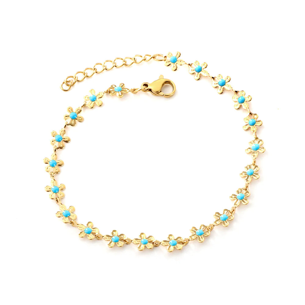 Introducing our Azure Bloom Bracelet, a captivating blend of modern aesthetics and timeless charm. This exquisite piece is meticulously crafted from high-quality stainless steel, accentuated by a layer of lustrous 18K Gold plating. The result is a stunning accessory that seamlessly combines durability with an elegant touch.