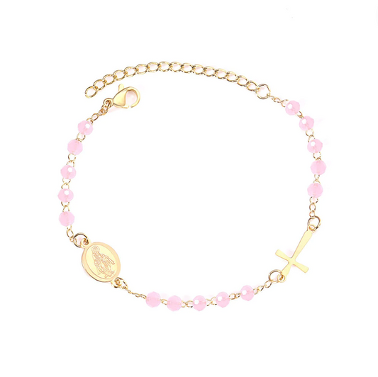 Introducing the 'Blush Blessings Rosary' – where spirituality meets a touch of rosy radiance! This stainless steel beauty dipped in 18k gold boasts enchanting pink beads and a divine 18k gold cross. At 20 cm, it's a harmonious blend of elegance and charm, with an extra 5 cm extension for those days when your style craves a little more grace.