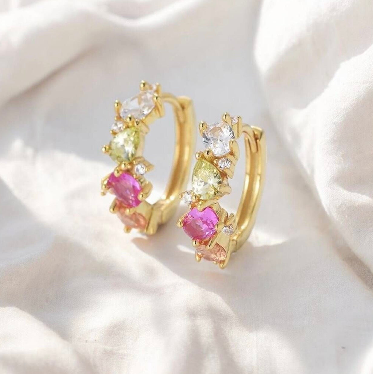 Crafted from premium 925 sterling silver and finished with 18K gold PVD plating, The Confetti Hoops offer lasting shine, durability, and a smooth, high-quality finish. The petite hoop silhouette keeps the design elegant and balanced, while the multi-coloured stones create a cheerful, confetti-like sparkle that brightens any look.