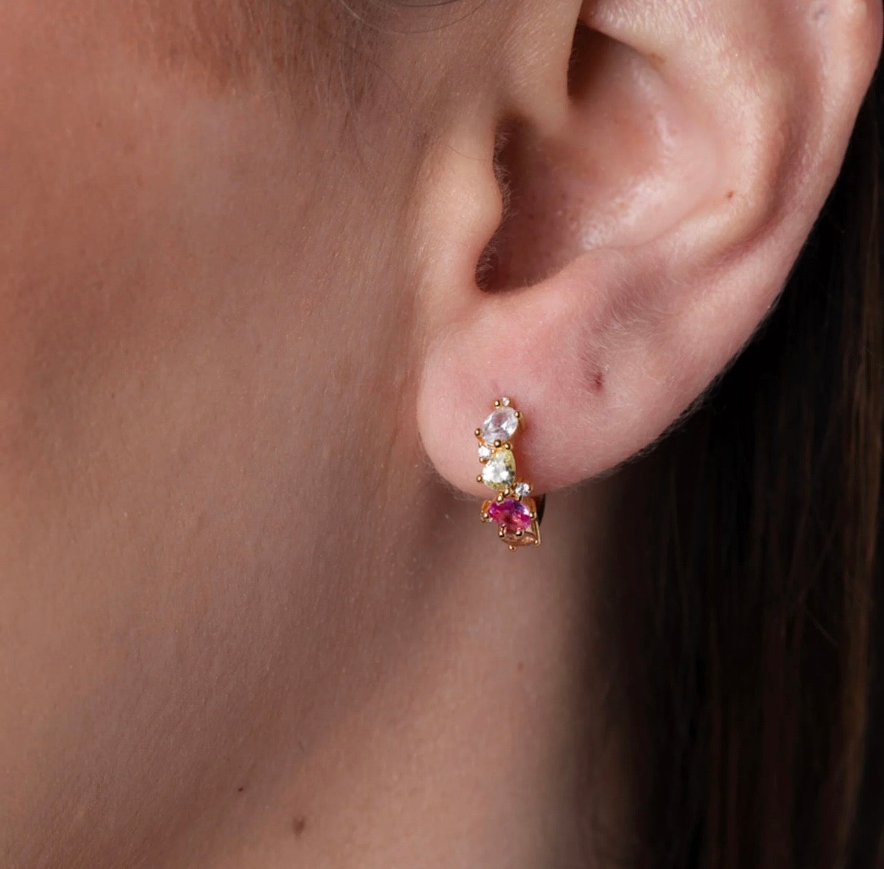 Crafted from premium 925 sterling silver and finished with 18K gold PVD plating, The Confetti Hoops offer lasting shine, durability, and a smooth, high-quality finish. The petite hoop silhouette keeps the design elegant and balanced, while the multi-coloured stones create a cheerful, confetti-like sparkle that brightens any look.