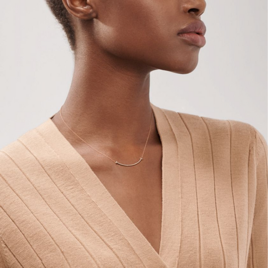 Elegant rose gold necklace featuring a sleek “T” pendant adorned with sparkling premium diamond simulants. The pendant hangs on a delicate adjustable chain, radiating modern luxury and timeless sophistication.