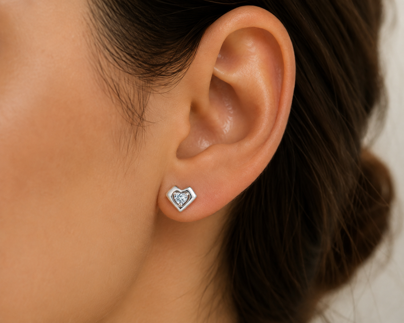 Elevate your everyday style with the Heart Solitaire Stud Earrings.&nbsp;Designed with a timeless heart silhouette, each earring features a brilliant heart-shaped diamond simulant that captures the light beautifully, creating an elegant sparkle for every occasion

Crafted from premium 925 Sterling Silver and finished with a luxurious Rhodium Plating, these earrings offer lasting shine while helping protect against tarnishing. Their classic design makes them perfect for daily wear, special occasions, giftin