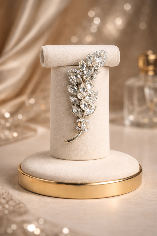 Elevate your style with our Leaf Design Crystal Brooch, a refined statement piece designed to bring effortless luxury to your wardrobe. Inspired by nature’s elegance, this crystal brooch features a delicate leaf silhouette adorned with brilliant diamond simulants and shimmering crystals that catch the light from every angle.

Expertly crafted from 925 sterling silver and finished with a thick layer of gold plating, this high-quality brooch offers both durability and a rich, polished finish. The combination 