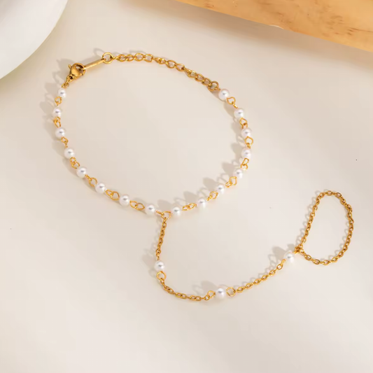 Gold-dipped stainless steel Pearly Link Bracelet featuring lustrous imitation pearls, connected by a delicate chain linking a ring and bracelet; elegant, feminine, and modern jewelry design