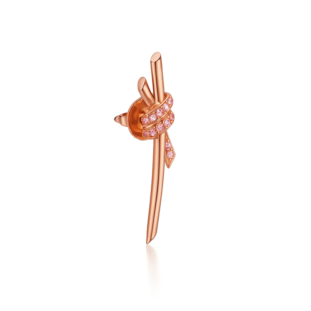 The Knot is a symbol of life’s most enduring ties and meaningful connections. The Knot of Love Earrings are masterfully dipped in 18k rose gold and accented with hand-set round brilliant diamond simulants, each selected for its exceptional fire and brilliance. Designed to capture both elegance and meaning, this piece represents unity, devotion, and everlasting beauty.

Post-back closure