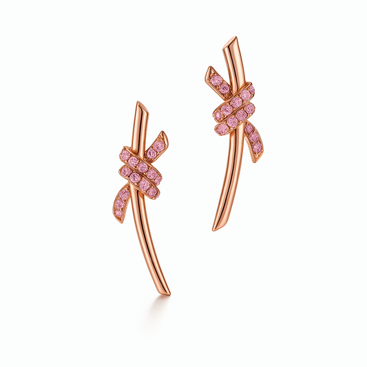 The Knot is a symbol of life’s most enduring ties and meaningful connections. The Knot of Love Earrings are masterfully dipped in 18k rose gold and accented with hand-set round brilliant diamond simulants, each selected for its exceptional fire and brilliance. Designed to capture both elegance and meaning, this piece represents unity, devotion, and everlasting beauty.

Post-back closure.&nbsp;