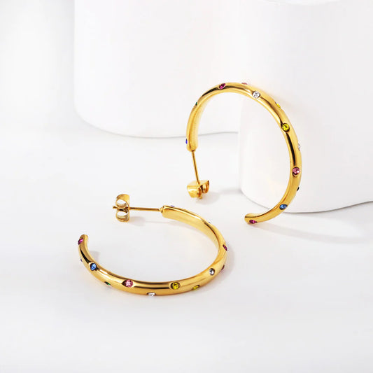 Discover affordable luxury with our "Celestial" Hoop Earrings. Made from 18k gold-plated stainless steel, these earrings feature captivating multicolor diamond stimulant dots for a celestial touch. Elevate your style effortlessly with this timeless and versatile accessory. Perfect for casual or formal occasions, these hoops seamlessly combine quality craftsmanship with on-trend design. Add a touch of celestial glamour to your collection today! Shop now for a radiant and affordable statement piece.