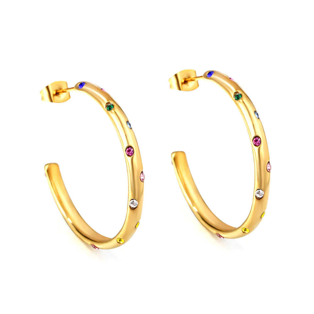 Witness the versatility of our "Celestial" Hoop Earrings as they are elegantly styled, making a statement whether paired with casual attire or complementing a more formal ensemble. A close-up shot capturing the mesmerizing details of the multicolor diamond stimulant dots, revealing the brilliance and celestial allure of these stunning hoop earrings.