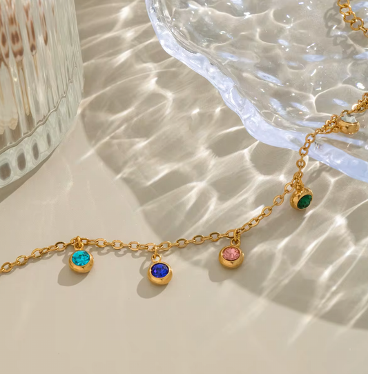 Radiate color and confidence with the&nbsp;Celestial Spectrum Bracelet — a luminous piece that captures the beauty of the cosmos. Crafted from premium stainless steel and dipped in rich gold, this bracelet features a stunning array of multi-coloured diamond simulants that shimmer with every movement.

Elegant yet playful, it’s the perfect statement of luxury for everyday wear or a special night out. The celestial hues reflect light like a starry sky — bold, radiant, and utterly unforgettable.