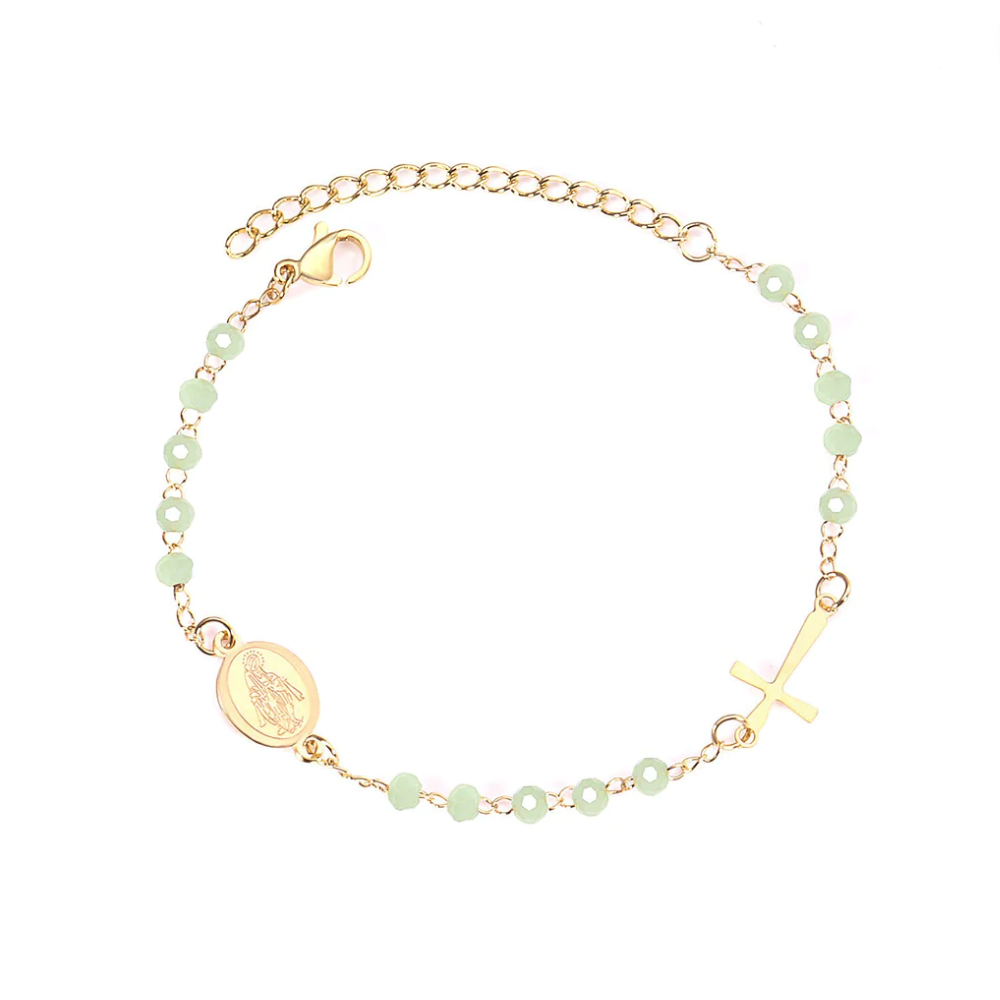 Step into the serene embrace of our 'Golden Meadow Rosary'! Crafted from stainless steel dipped in 18k gold, this enchanting rosary features light green beads and a divine 18k gold cross. At 20 cm, it's a playful fusion of elegance and nature's grace, with an extra 5 cm extension for those days when your style craves a little more sunshine.