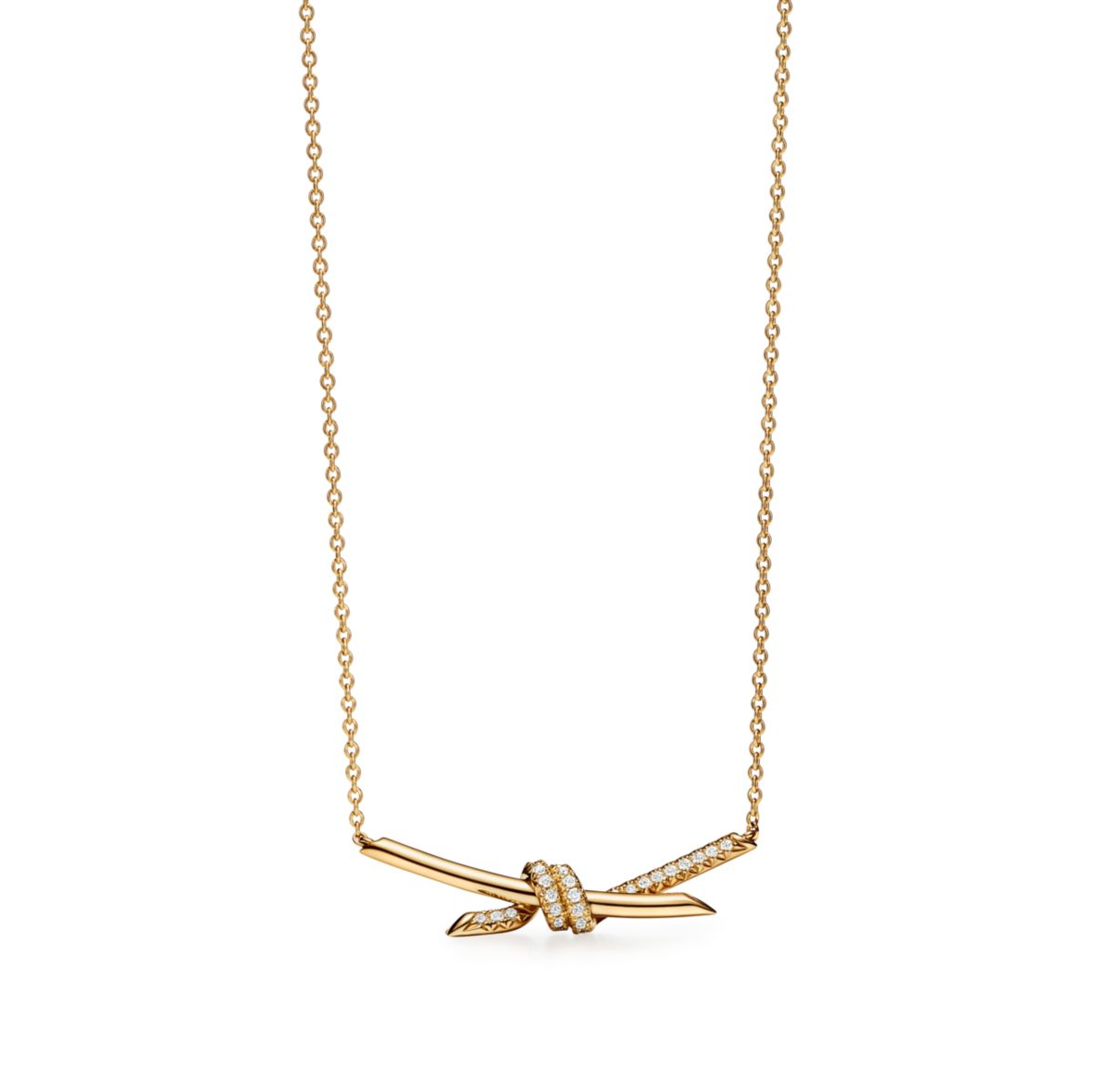 The Knot is a symbol of life’s most enduring ties and meaningful connections. Crafted in 18k yellow gold and illuminated with round brilliant diamonds, the Knot of Love Necklace reflects the beauty of unity and devotion. Each diamond is hand-set to ensure maximum brilliance, complementing the smooth, polished gold finish.

Designed with versatility in mind, the necklace features three adjustable links at the back, making it perfect for stacking with other chains or wearing at different lengths. A refined pi
