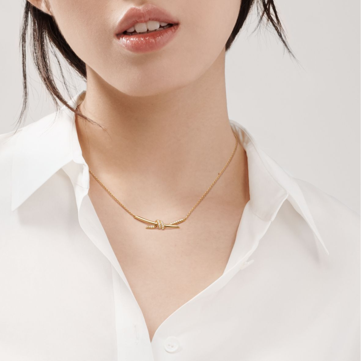 The Knot is a symbol of life’s most enduring ties and meaningful connections. Crafted in 18k yellow gold and illuminated with round brilliant diamonds, the Knot of Love Necklace reflects the beauty of unity and devotion. Each diamond is hand-set to ensure maximum brilliance, complementing the smooth, polished gold finish.

Designed with versatility in mind, the necklace features three adjustable links at the back, making it perfect for stacking with other chains or wearing at different lengths. A refined pi