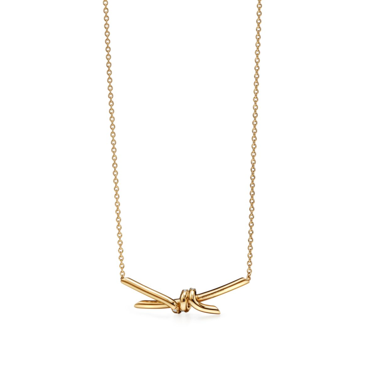 The Knot is a symbol of life’s most enduring ties and meaningful connections. Crafted in 18k yellow gold and illuminated with round brilliant diamonds, the Knot of Love Necklace reflects the beauty of unity and devotion. Each diamond is hand-set to ensure maximum brilliance, complementing the smooth, polished gold finish.

Designed with versatility in mind, the necklace features three adjustable links at the back, making it perfect for stacking with other chains or wearing at different lengths. A refined pi
