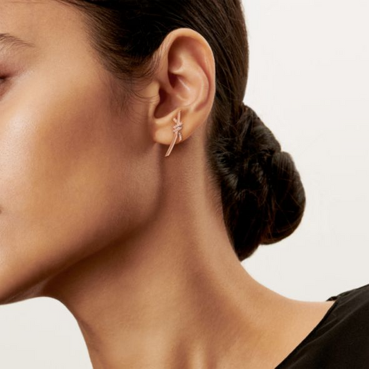 The Knot is a symbol of life’s most enduring ties and meaningful connections. The Knot of Love Earrings are masterfully dipped in 18k rose gold and accented with hand-set round brilliant diamond simulants, each selected for its exceptional fire and brilliance. Designed to capture both elegance and meaning, this piece represents unity, devotion, and everlasting beauty