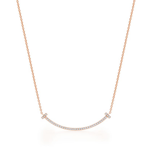 Elegant rose gold necklace featuring a sleek “T” pendant adorned with sparkling premium diamond simulants. The pendant hangs on a delicate adjustable chain, radiating modern luxury and timeless sophistication.