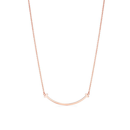 Where modern elegance meets everlasting style. The Timeless T Necklace is a true statement of sophistication — crafted with precision and dipped in luminous 18k rose gold for a radiant, romantic glow. Its sleek, minimalist “T” design symbolizes strength, connection, and balance — making it the perfect piece for the woman who embodies quiet confidence and timeless grace.

Whether worn alone for an understated look or layered for a touch of modern glamour, the Timeless T transcends trends and seasons — a fore