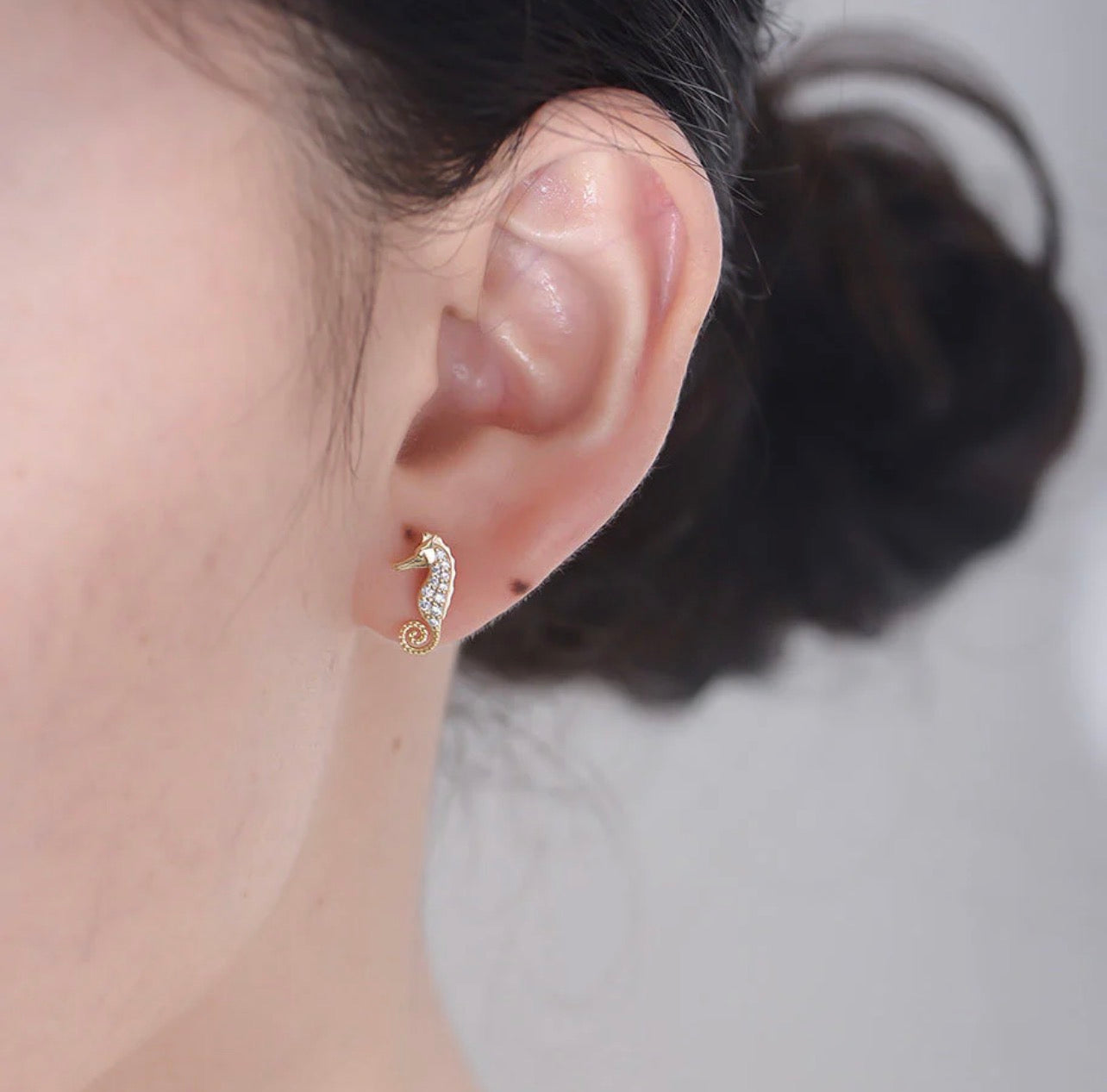 Crafted from premium 925 sterling silver and finished with 18-carat yellow gold vermeil, The Seahorse Studs offer lasting shine, durability, and a luxurious feel. Their petite size and smooth contours make them effortless to wear, while the symbolic seahorse design adds character and meaning without overpowering your look.

Lightweight, hypoallergenic, and tarnish-resistant, The Seahorse Studs are designed for all-day comfort and long-lasting wear. Whether worn alone for a subtle coastal accent or layered w