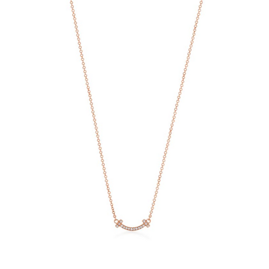 Elegant rose gold necklace featuring a sleek “T” pendant adorned with sparkling premium diamond simulants. The pendant hangs on a delicate adjustable chain, radiating modern luxury and timeless sophistication.