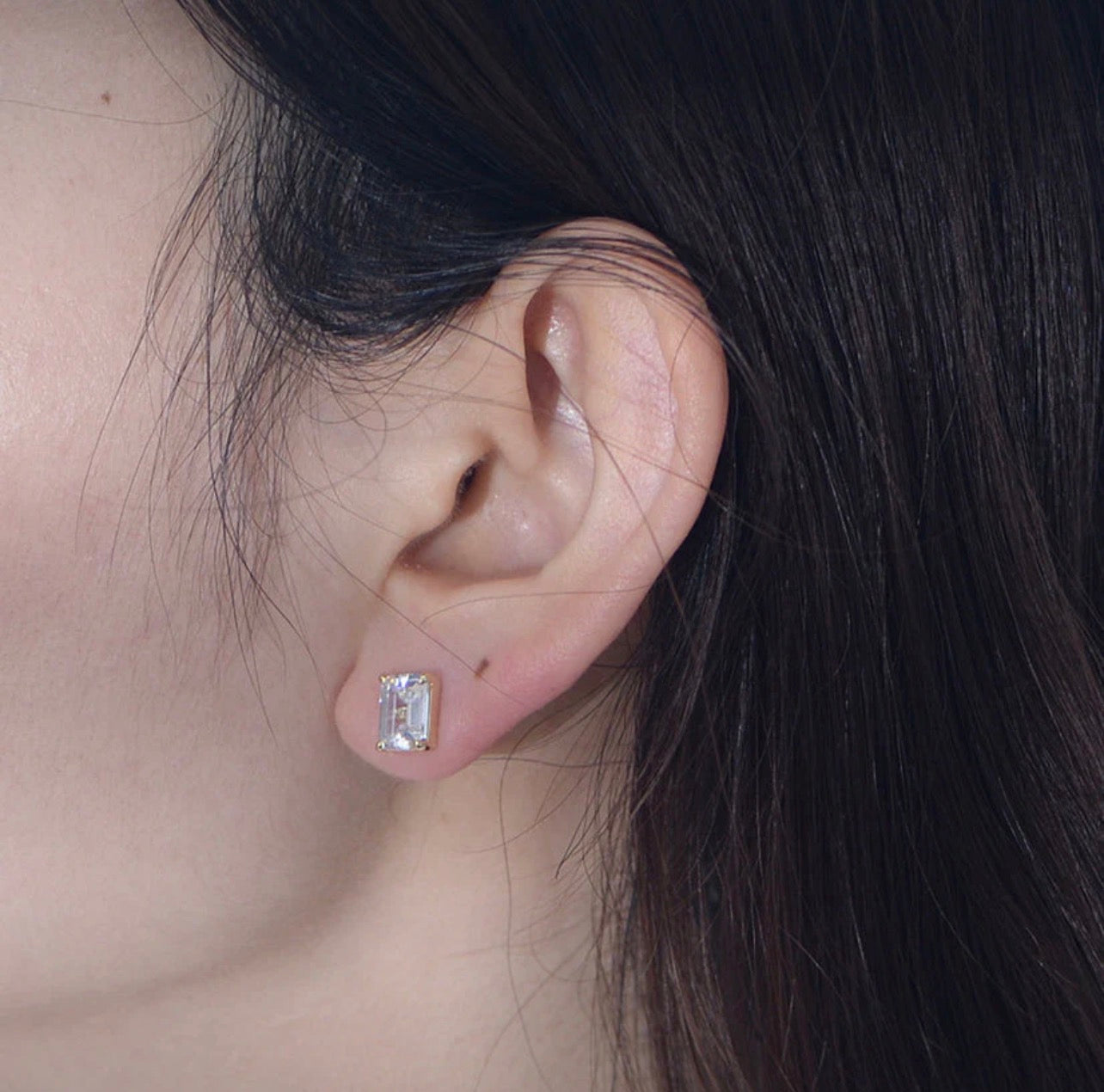 Infuse your daily wardrobe with a sense of timeless elegance with The Emerald-Cut Studs. Inspired by the grandeur of Art Deco design, these earrings feature a striking rectangular silhouette that emphasizes clarity and sophisticated geometry. The stepped facets of the emerald-cut stones catch the light with a subtle, hall-of-mirrors effect, offering a refined sparkle that is both understated and undeniably luxurious.